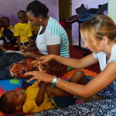 A female Projects Abroad internship student doing light stretches with children during her occupational therapy internship in Tanzania. Projects Abroad Intern doing stretches with local children during her occupational therapy internship in Tanzania.